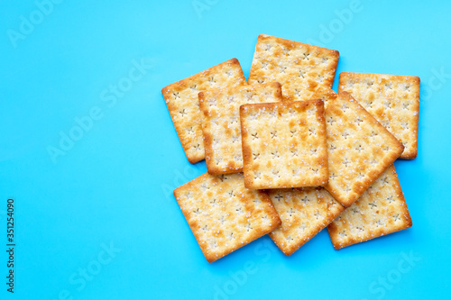 Crackers with sugar on blue background.