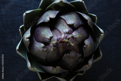 Top view photography of an artichoke on slate for food background