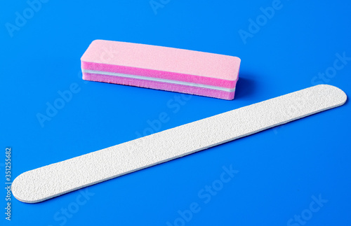 Sanding file sponge for manicure and nailfile on a blue background