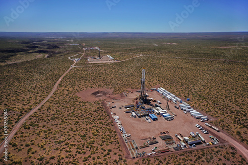 Vaca Muerta, Argentina, December 2, 2014: Extraction of unconventional oil. Battery of pumping trucks for hydraulic fracturing (Fracking).