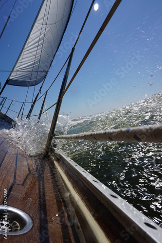 Sailing on a sailboat with wind, waves and spray. Being outside and being moved by natural energy. A green environment and good for the well-being of humans and animals.