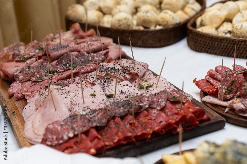 
table of fiembres presented in tables and sources in a banquet with variety of sausages and decoration