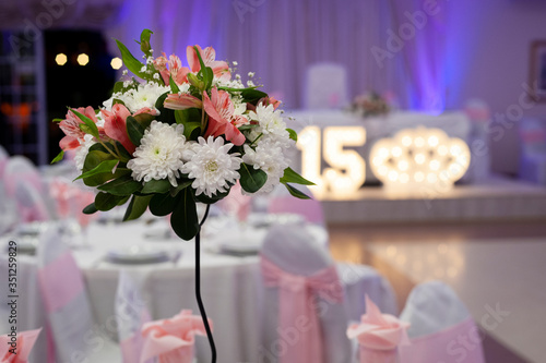  floral decoration on table in party room for an event, decoration centerpieces with natural flowers 