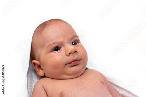 Adorable 2 months old little baby boy on towel after bath over white background