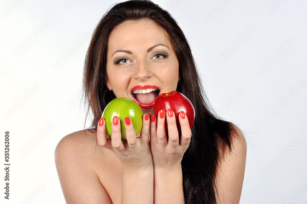 Healthy Teeth. Young Lady Biting Red and Green Apple Posing On White Studio Background. Healthy Teeth. Young Lady Biting Red and Green Apple Posing On White Studio Background.