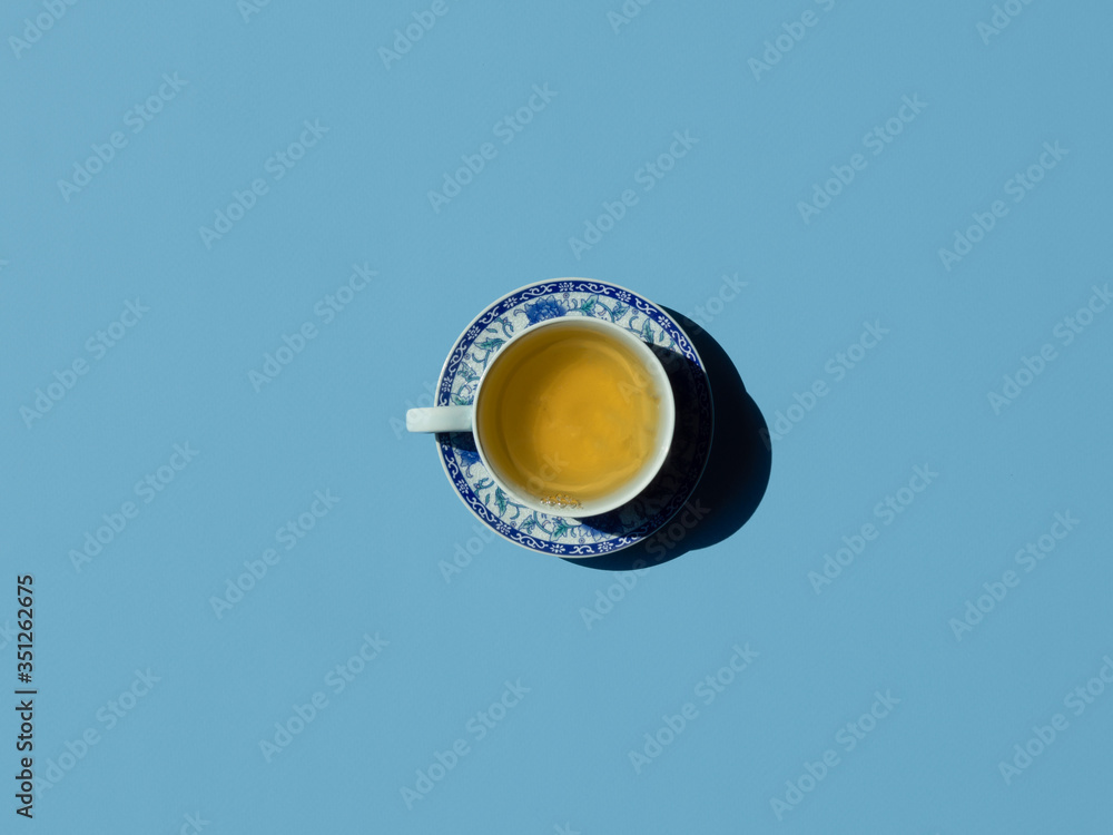chinaware with green tea. top view on blue background. copy space chinaware with green tea. top view on blue background. copy space