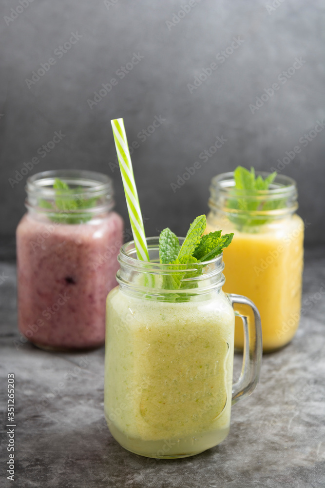 Assortment of fruit smothie in glass jars, summer refreshing drinks. Assortment of fruit smothie in glass jars, summer refreshing drinks.