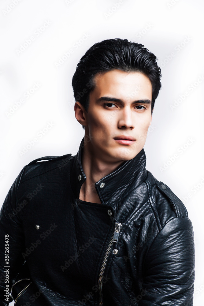 young handsome man, leather jacked on naked torso, emotional posing, white background, modern guy, lifestyle people concept young handsome man, leather jacked on naked torso, emotional posing, white background, modern guy, lifestyle people concept