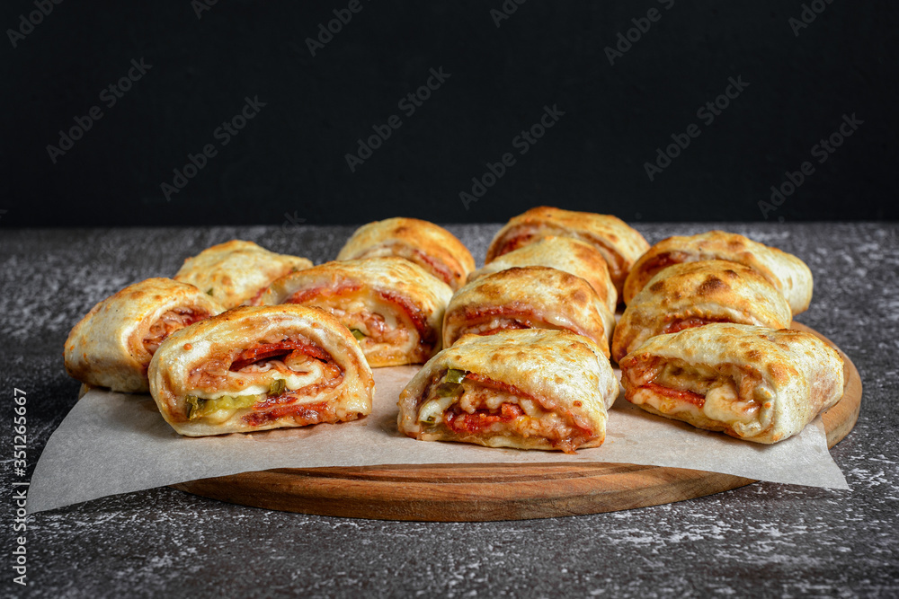 Mini pizza rolls on wooden board