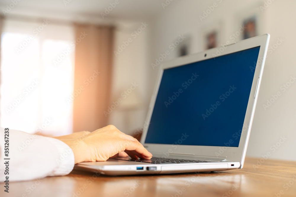 Close-up female hands on a laptop keyboard, laptop with blank screen. Freelance, developer Close-up female hands on a laptop keyboard, laptop with blank screen. Freelance, developer