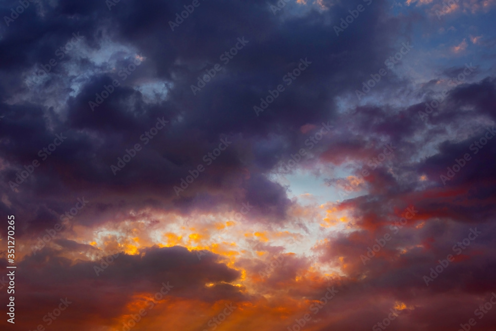 The sky in storm clouds at sunset. Bright fairy-tale sunset.