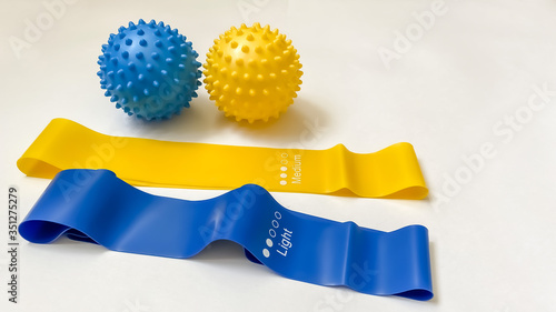 Set of colorful latex rubber bands for fitness on a white background.  massage balls.  sports concept.  fitness trend for home workouts.  top view, flat lay, copy space, isolate.