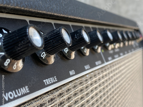Close-up vintage amplifier combo with black knob and control panel. clean and low-gain distortion for rock to metal, Blues, and jazz genres. Music business concept.