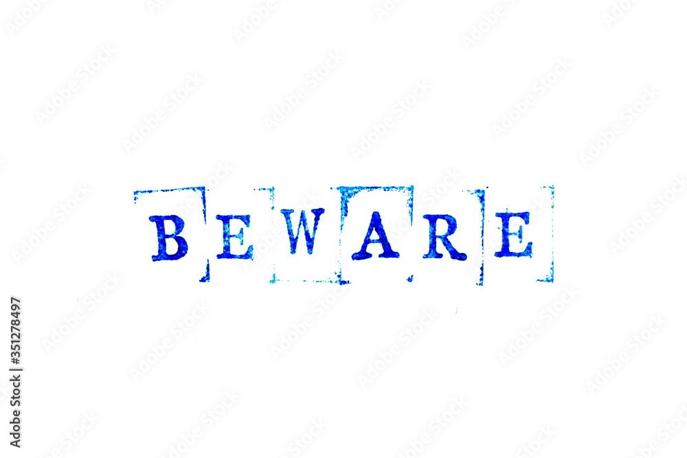 Blue ink of rubber stamp in word beware on white paper background Blue ink of rubber stamp in word beware on white paper background