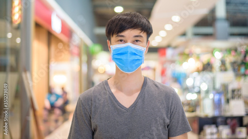 Asian man is wearing surgical mask in shopping mall