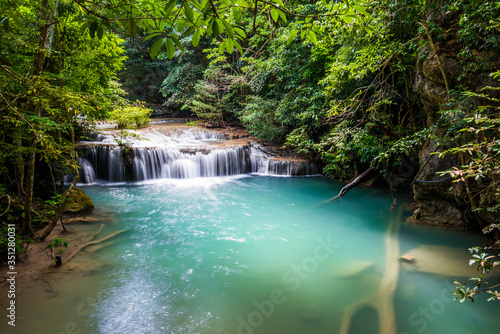 Waterfall and blue emerald water color in Erawan national park. Erawan Waterfall tier, Beautiful nature rock waterfall steps in tropical rainforest at Kanchanaburi province, Thailand