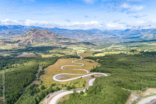 Aerial view of the curved asphalt road trough mountains. Carretera Austral road near the Cerro Castillo National Park. Chile