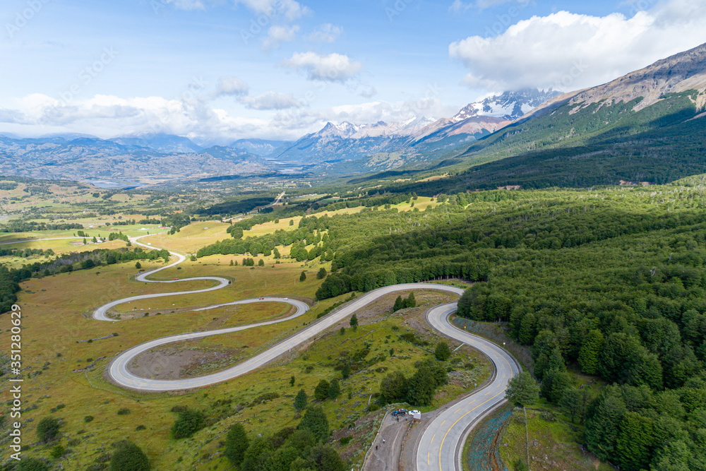 Aerial view of the curved asphalt road trough mountains. Carretera Austral road near the Cerro Castillo National Park. Chile