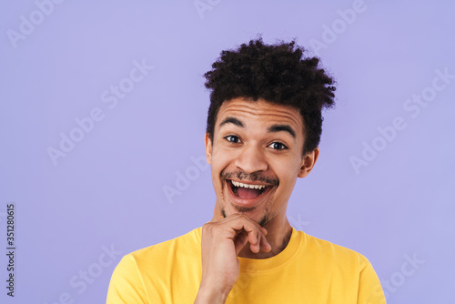 Photo of excited african american man smiling and looking upward