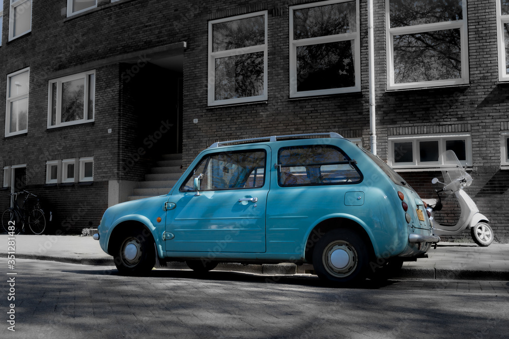Fototapeta premium Blue vintage vehicle on a black and white background