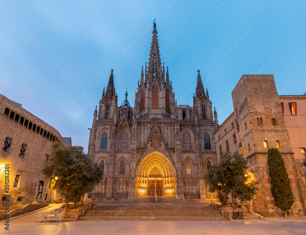 Barcelona - The facade of old gothic cathedral of the Holy Cross and Saint Eulalia at dusk.
