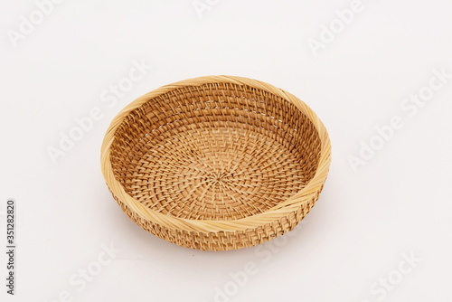 A woven bamboo basket isolated against a white background