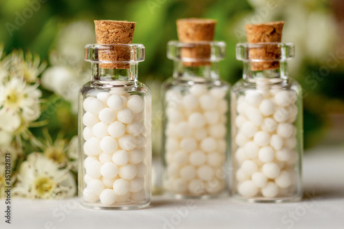 Obraz na plátně Homeopathy globules in bottles
