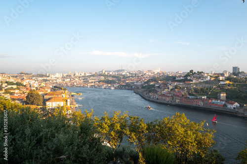 Public park of Porto at sunset with the Douro River in the background.