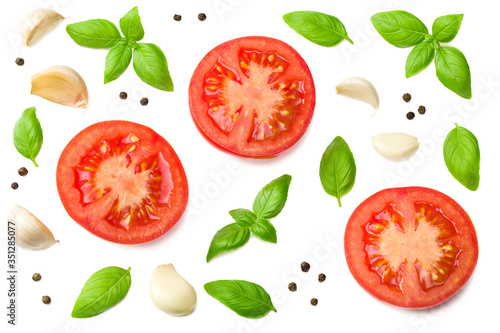 tomato slices with garlic and basil isolated on white background, top view