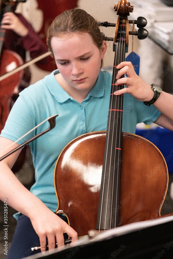 Teenage girl playing cello in classroom Teenage girl playing cello in classroom