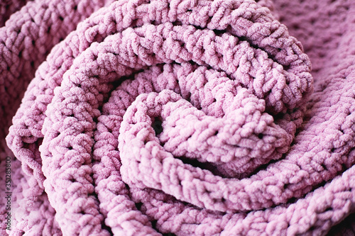 Texture of pink knit blanket. Plaid merino wool.