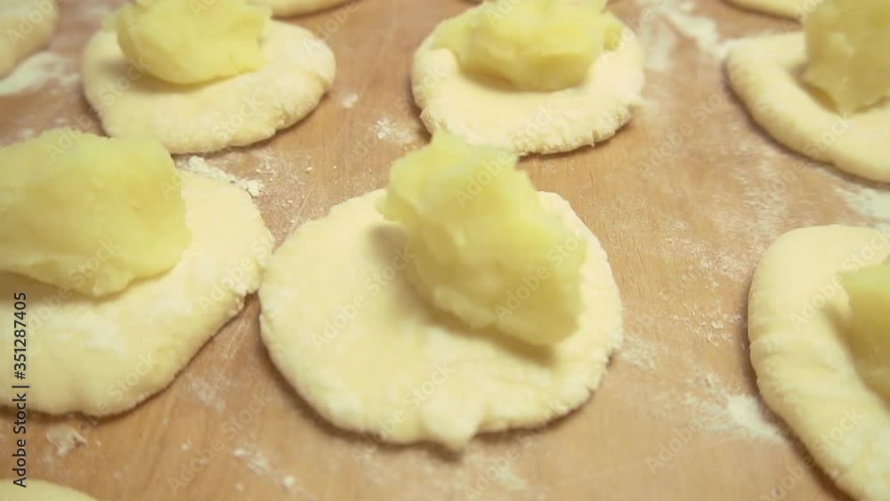Lush dough. Roll out the yeast dough to make pies with potatoes and onions and dill on a wooden Board or a dark plate Lush dough. Roll out the yeast dough to make pies with potatoes and onions and dill on a wooden Board or a dark plate