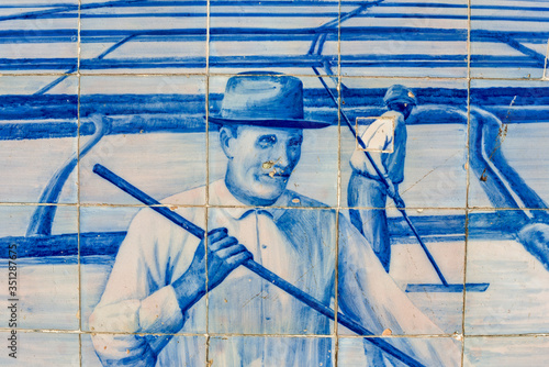 azulejos panels on the facade of the old railways station describing the salt marshes in Aveiro, Portugal