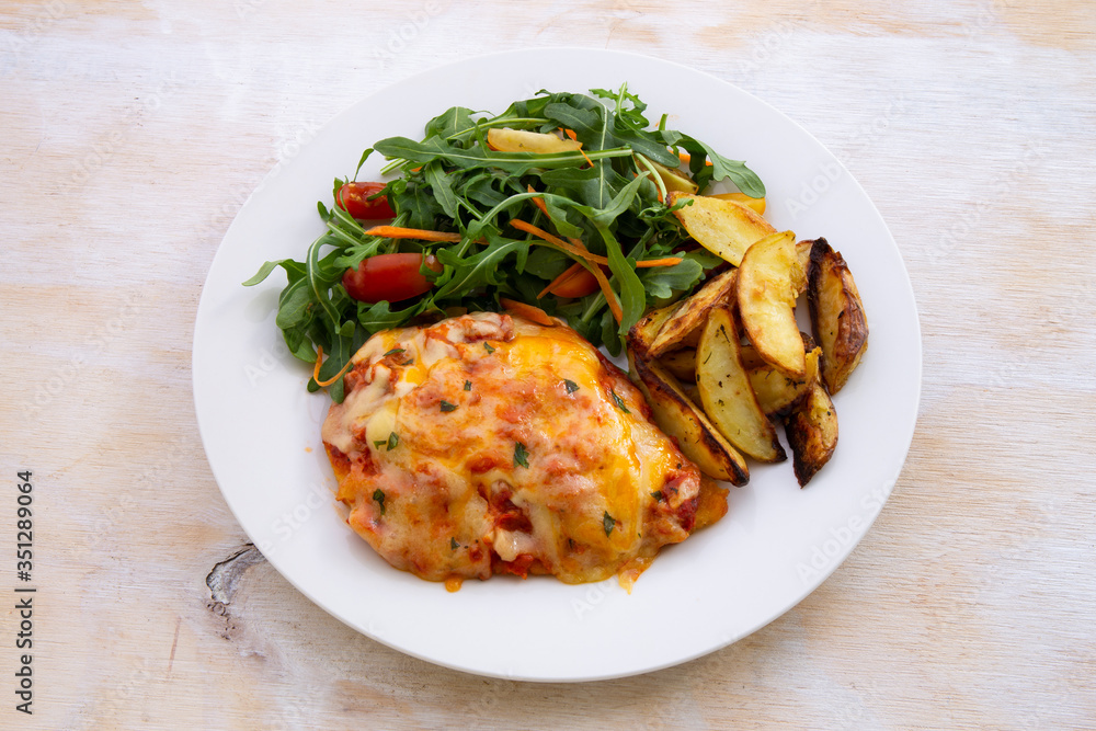 Chicken Parmesan Baked in Tomato Sauce with cheese, chips Chicken Parmesan Baked in Tomato Sauce with cheese, chips