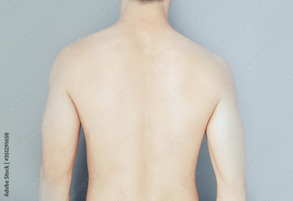 Closeup back of man on grey background beauty healthy skin care concept Closeup back of man on grey background beauty healthy skin care concept