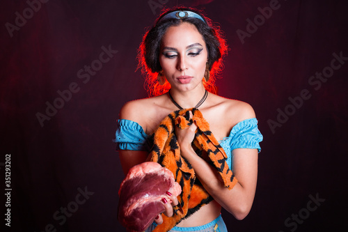 Stop animal killing concept - Pretty girl show animal skin and raw meat that she wants to tell someone don't kill animals or stopped violence against animal.