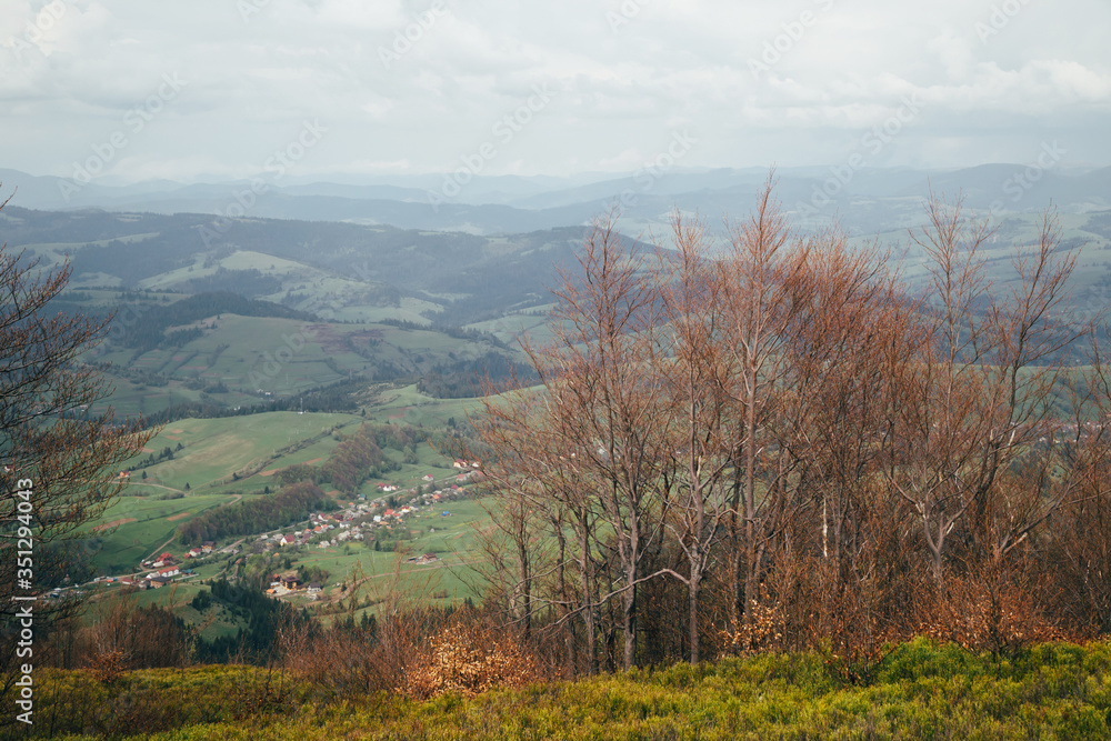A view from the top of the mountain Gemba or Gimba down to the meadow and village Pilipec, Carpathian mountains, Ukraine. Silence and harmony of nature A view from the top of the mountain Gemba or Gimba down to the meadow and village Pilipec, Carpathian mountains, Ukraine. Silence and harmony of nature