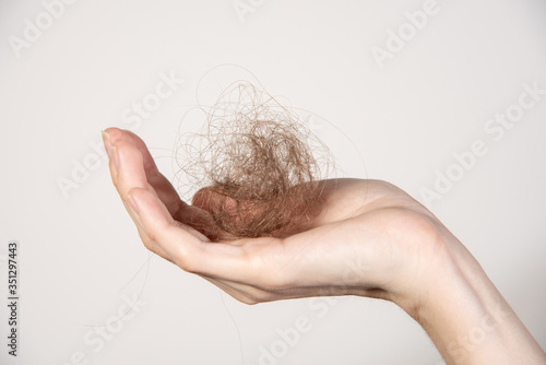 Hair loss. Hands with shreds of hair close-up