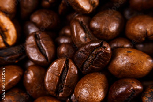 Coffee beans close-up. Macro shooting. Small depth of field. Blurred the edges of the frame.
