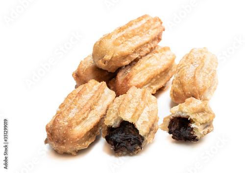 Homemade baked mini chocolate filled churros isolated on white