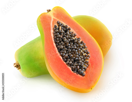 One whole multicolored papaya fruit and a half with seeds isolated over white background photo