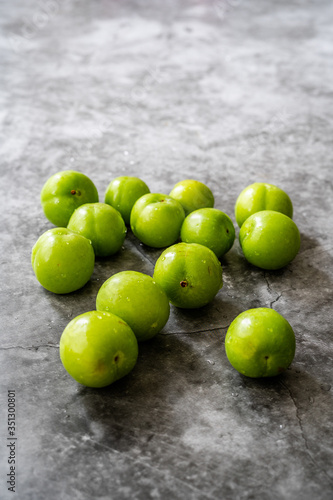 Raw Organic Sour Green Plums Ready to Eat.