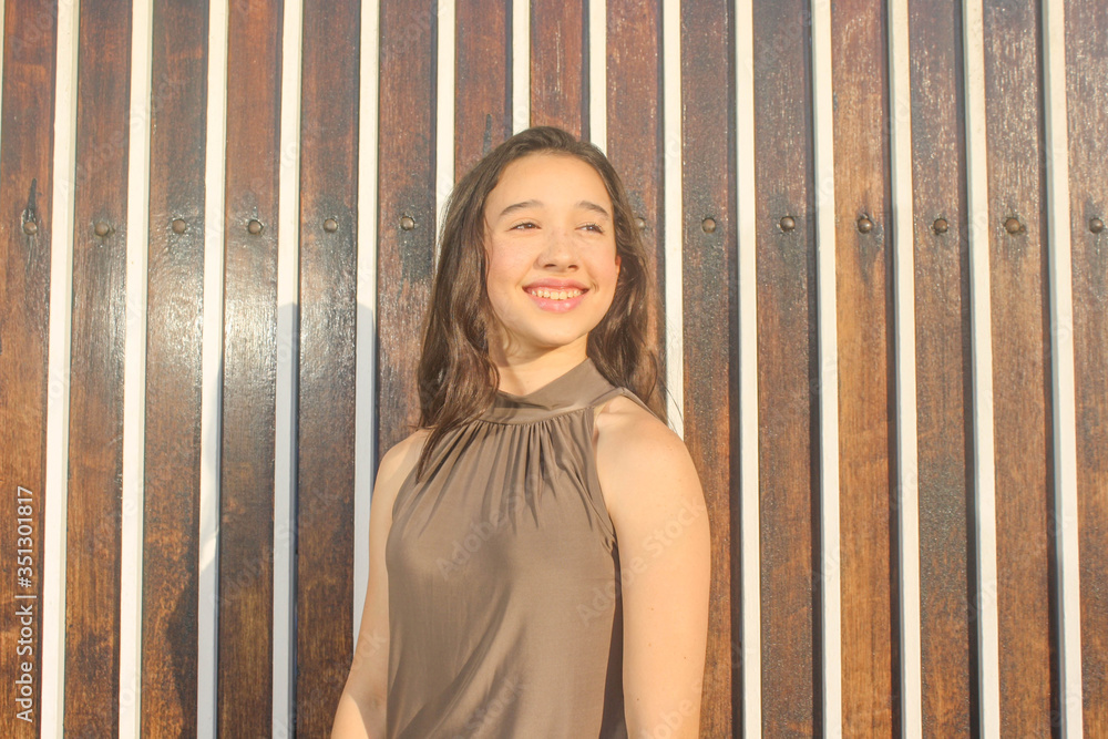 teenager smiling with wooden planks background teenager smiling with wooden planks background