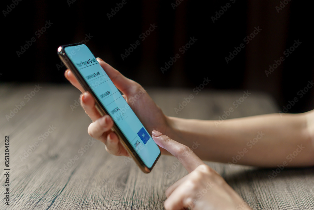 Woman hand holding smartphone. Payment or play. (Fake Screen) Woman hand holding smartphone. Payment or play. (Fake Screen)