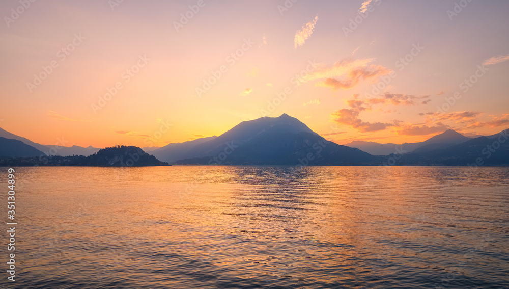 Panoramic view of sunset behind Alps mountains and Como lake, Italy.