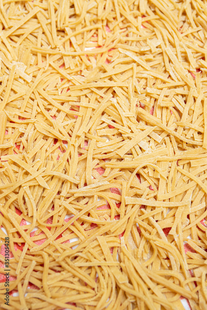 Homemade pasta made from wholesome whole wheat flour on a kitchen cloth.