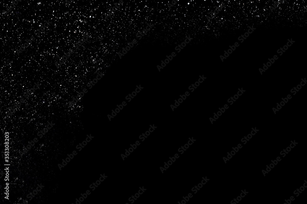 White falling snow on a black background. White noise on the left side, the right side of the photo is black White falling snow on a black background. White noise on the left side, the right side of the photo is black