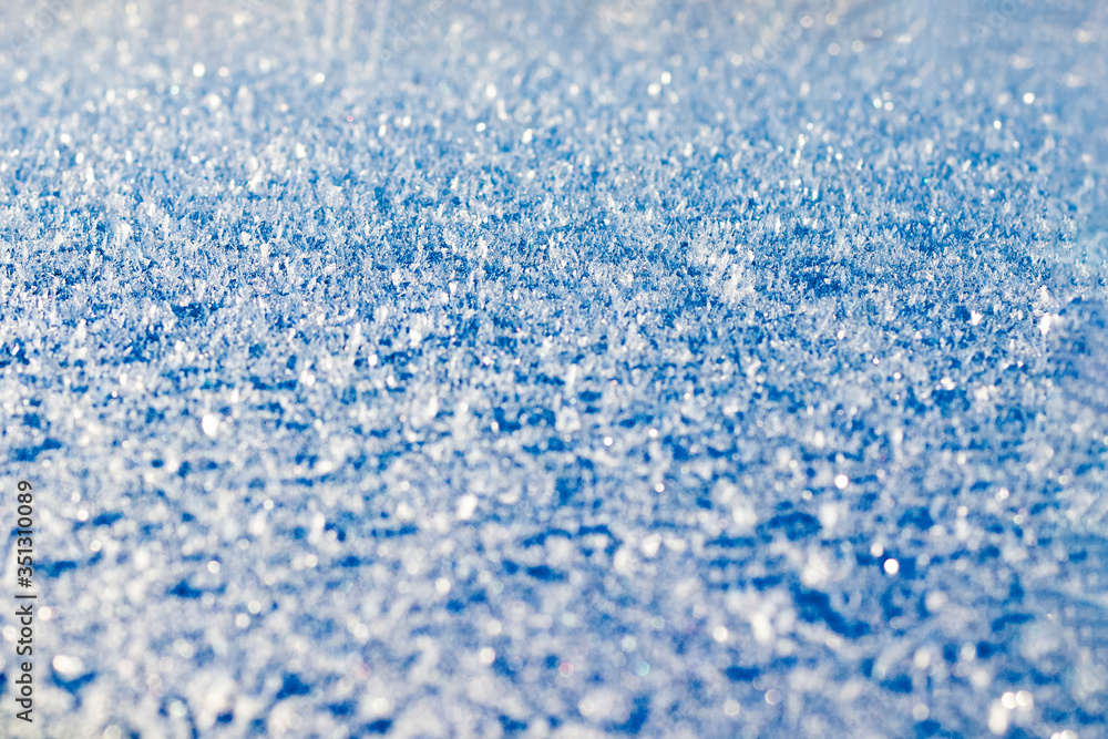 Obraz premium Hoarfrost on the surface. Background. Copy space. Close-up. Toned in blue