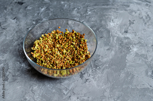 lentils in a transparent bowl on a grey background