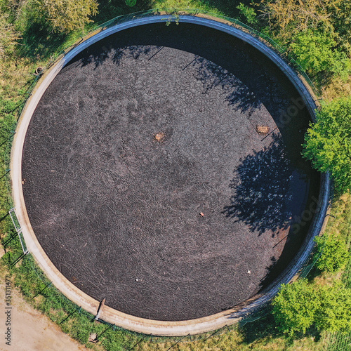 Fototapet Vertical view down to a large circular tank for the storage of liquid manure